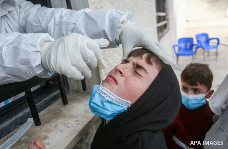 A medic from the Palestinian Health Ministry takes swab samples from people to test for the coronavirus, in the West Bank city of Nablus on January 31, 2022. Daily Covid-19 cases in Palestine continued to rise and reache...