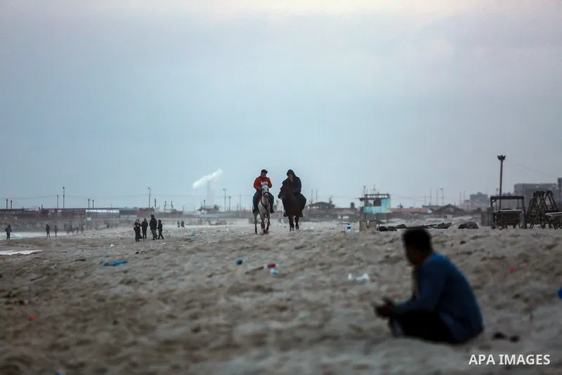 Palestinians enjoy on the beach of Gaza city on January 31, 2022. The beach is one of the few open public spaces in this densely populated city. Now a ceaseless conflict that seems to impinge on nearly every aspect of li...