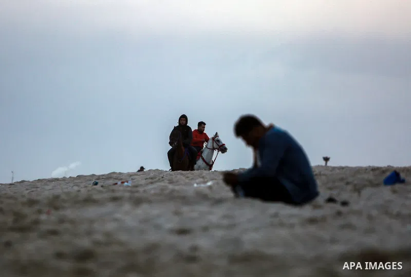 Palestinians enjoy on the beach of Gaza city on January 31, 2022. The beach is one of the few open public spaces in this densely populated city. Now a ceaseless conflict that seems to impinge on nearly every aspect of li...