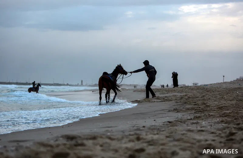 Palestinians enjoy on the beach of Gaza city on January 31, 2022. The beach is one of the few open public spaces in this densely populated city. Now a ceaseless conflict that seems to impinge on nearly every aspect of li...