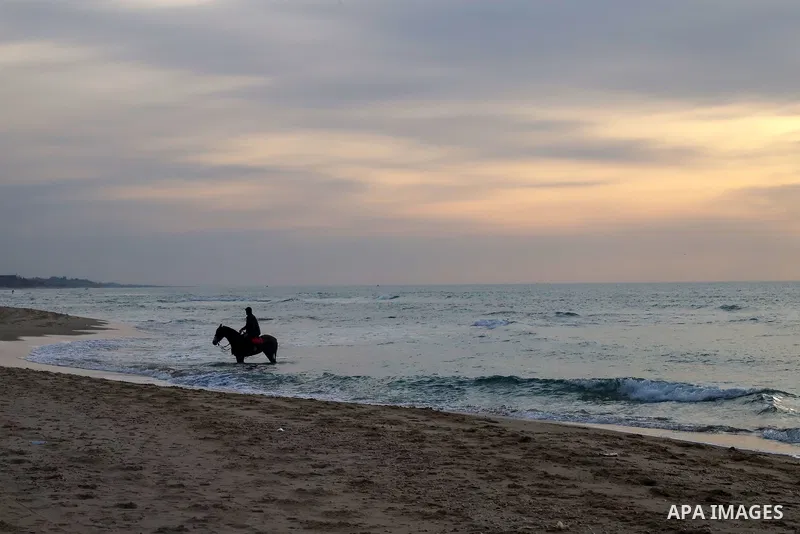 Palestinians enjoy on the beach of Gaza city during sunset on Feb. 02, 2022. The beach is one of the few open public spaces in this densely populated city. Now a ceaseless conflict that seems to impinge on nearly every a...