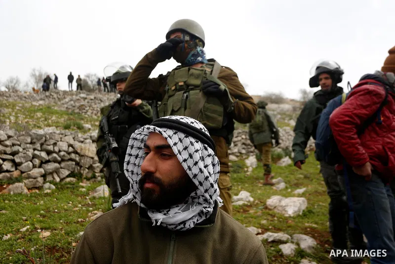 Israeli soldiers prevent Palestinians, Israeli activists and members of Knesset plant olive trees near outpost of Givat Ronen in Burin village, near the West Bank city of Nablus on February 4, 2022. Photo by Shadi Jarar'...