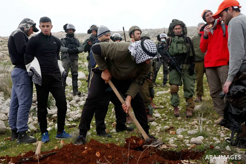 Israeli soldiers prevent Palestinians, Israeli activists and members of Knesset plant olive trees near outpost of Givat Ronen in Burin village, near the West Bank city of Nablus on February 4, 2022. Photo by Shadi Jarar'...