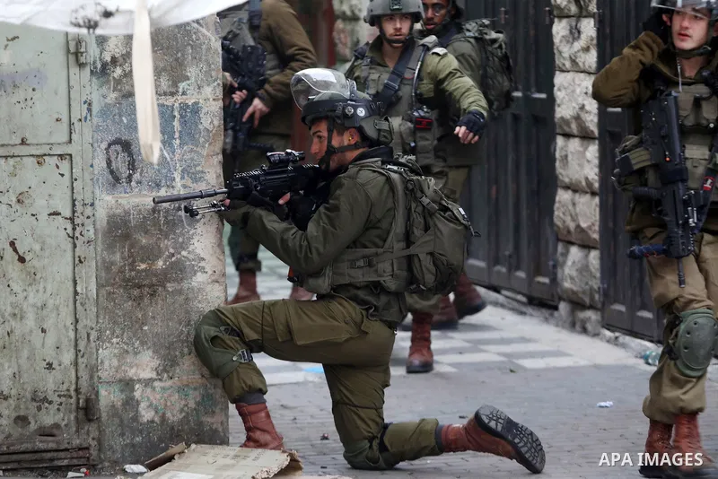 Israeli security forces take position during clashes with Palestinian protesters against settlements in the West Bank city of Hebron on Feb. 4, 2022. Photo by Mamoun Wazwaz
