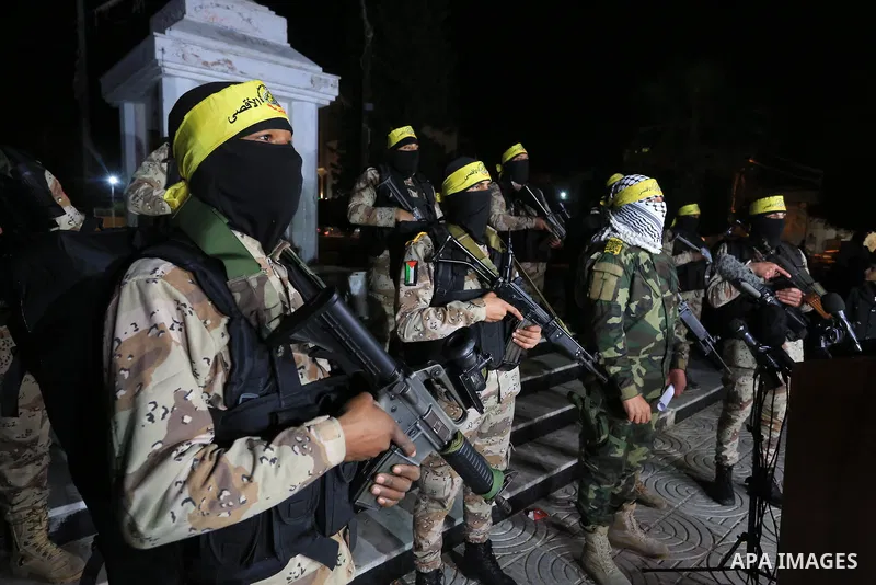 Members of Al-Aqsa Martyrs Brigade, an armed wing of the Fatah movement hold a press conference protesting the Israeli killing of three of its members in the West Bank early, in Gaza city on Feb. 08, 2022. Three Palestin...
