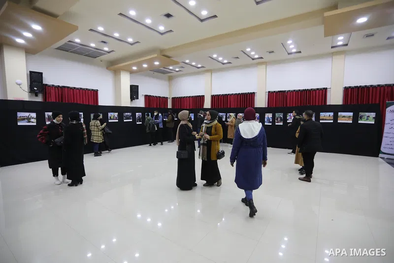 Palestinians participate in a photo exhibition to support Palestinian women, in Gaza city, on Feb. 10, 2022. Photo by Ashraf Amra