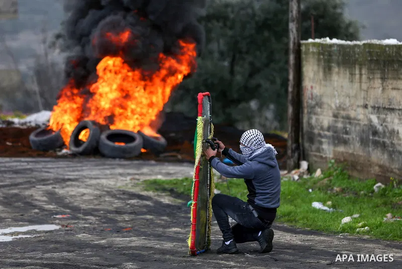 Palestinian protesters clash with Israeli security forces, following a demonstration against the expropriation of land by Israel in the village of Kfar Qaddum near the Jewish settlement of Kedumim in the West Bank on Feb...
