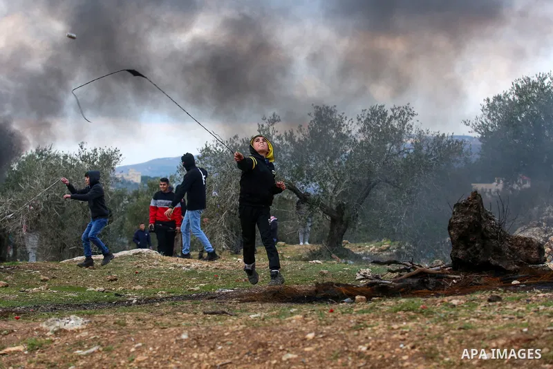 Palestinian protesters clash with Israeli security forces following a demonstration against settlements in the village of Beita, near the West Bank city of Nablus on Feb. 11, 2022. Photo by Wajed Nobani