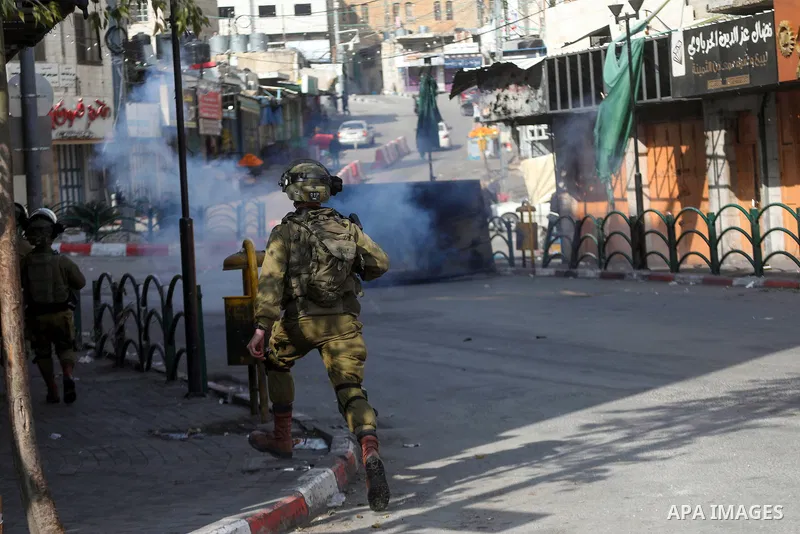 Israeli security forces take position during clashes with Palestinian protesters following the Friday prayers in the West Bank town of Hebron, February 18, 2022. Photo by Mamoun Wazwaz