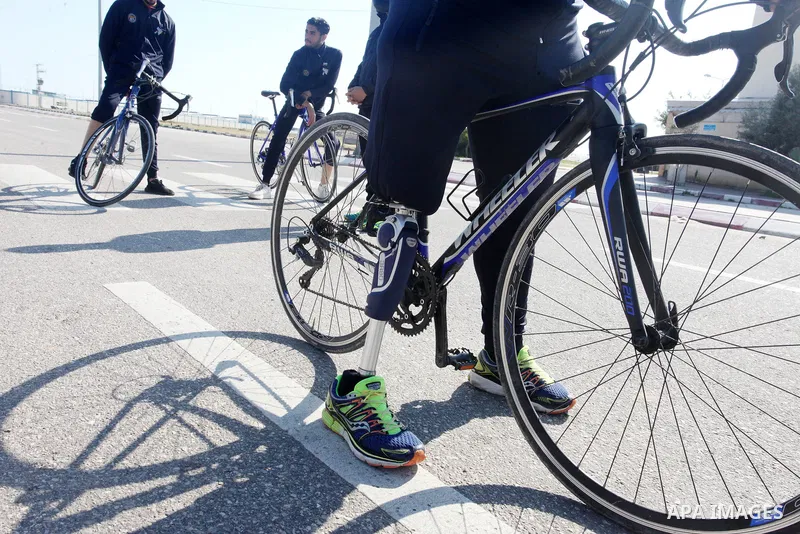 Palestinian cyclists attend a cycling training in Rafah in the southern Gaza Strip on February 20, 2022. A youth team of amputees trains to ride bicycles to prepare them for the Asian or European competitions. Photo by R...