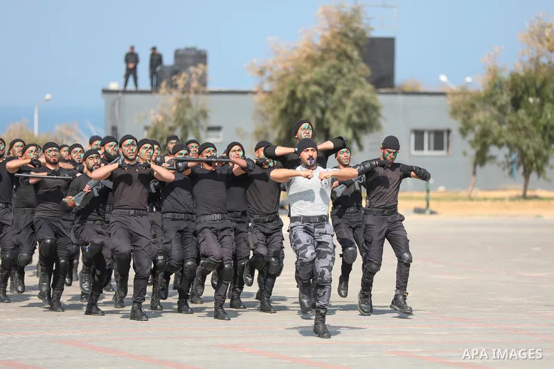 Palestinian policemen take part in a graduation ceremony, in Gaza City on February 21, 2022. Photo by Atia Darwish