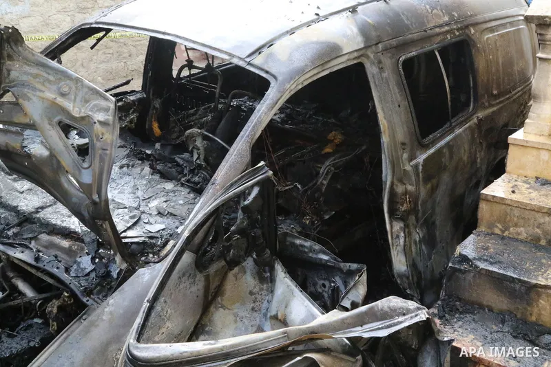 Security forces inspect the scene of an explosion that targeted the vehicle of and killed a member of the Syrian fighters in Syria's town of Azaz in northern countryside of Syria's Aleppo province near the border with Tu...