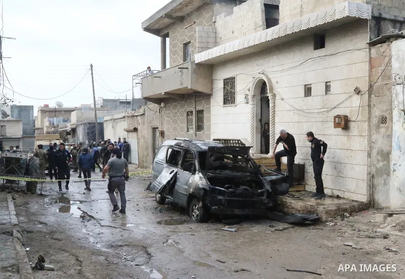 Security forces inspect the scene of an explosion that targeted the vehicle of and killed a member of the Syrian fighters in Syria's town of Azaz in northern countryside of Syria's Aleppo province near the border with Tu...