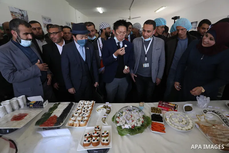 Japanese delegation attend the opening ceremony of the cheese factory in Rafah in the southern Gaza Strip on February 22, 2022. The project hosted by the Cooperative Agricultural Cooperative Sheep Breeders Association in...