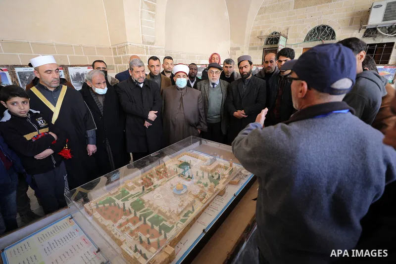 Palestinians attend an exhibition about Jerusalem in Great Omari Mosque, during activities of the International Al-Quds Week, in Gaza city on Feb. 25, 2022. Photo by Mahmoud Nasser