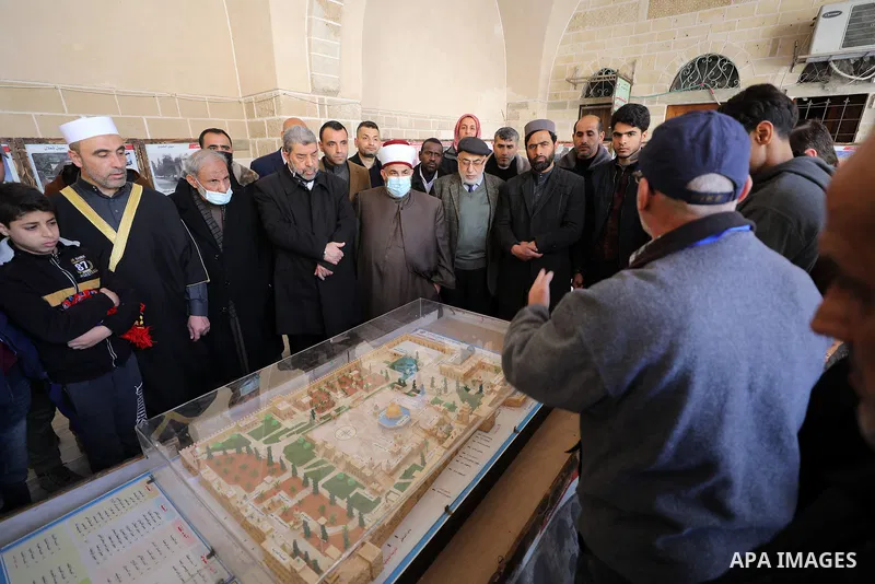 Palestinians attend an exhibition about Jerusalem in Great Omari Mosque, during activities of the International Al-Quds Week, in Gaza city on Feb. 25, 2022. Photo by Mahmoud Nasser