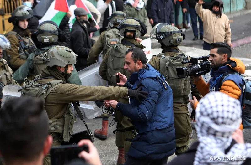 Palestinian protesters clash with Israeli forces following an annual demonstration in memory of the 1994 Ibrahimi Mosque massacre, near a gate leading to Hebron's main al-Shuhada street, on Feb. 25, 2022. Photo by Mamoun...