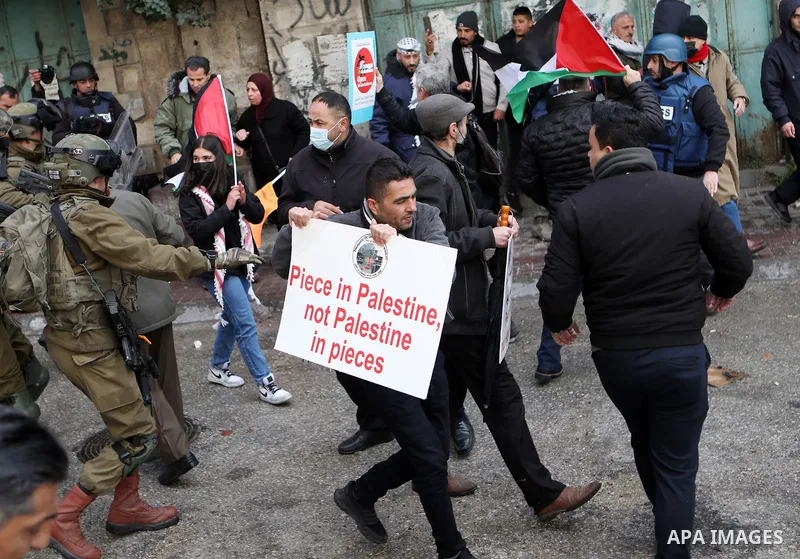 Palestinian protesters clash with Israeli forces following an annual demonstration in memory of the 1994 Ibrahimi Mosque massacre, near a gate leading to Hebron's main al-Shuhada street, on Feb. 25, 2022. Photo by Mamoun...