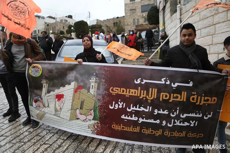 Protesters take part during an annual demonstration in memory of the 1994 Ibrahimi Mosque massacre, near a gate leading to Hebron's main al-Shuhada street, in the West Bank city of Hebron on Feb. 25, 2022. Photo by Mamou...