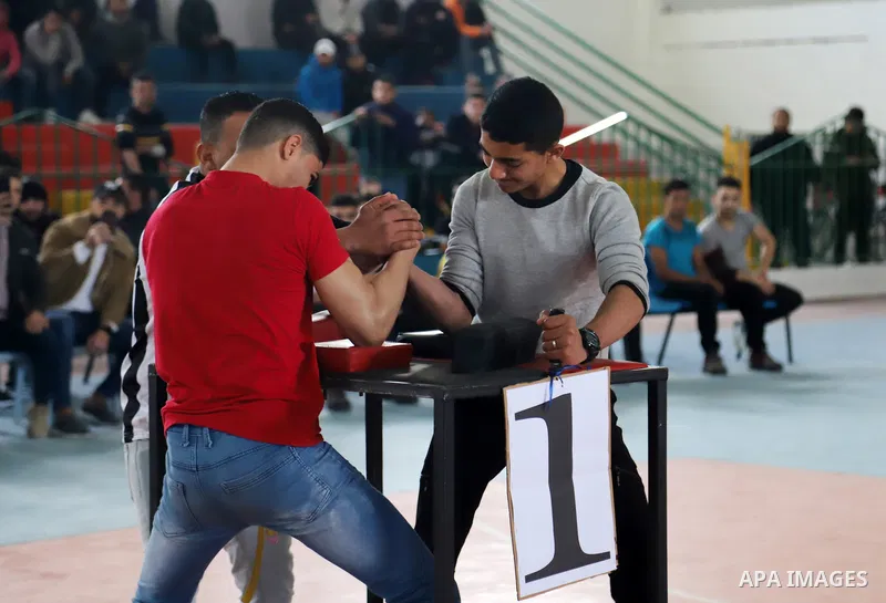 Palestinian youths compete in an arm-wrestling championship in Gaza City on February 25, 2022. Photo by Omar Ashtawy