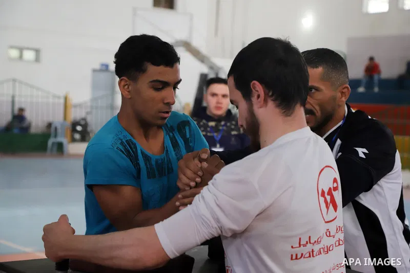 Palestinian youths compete in an arm-wrestling championship in Gaza City on February 25, 2022. Photo by Omar Ashtawy