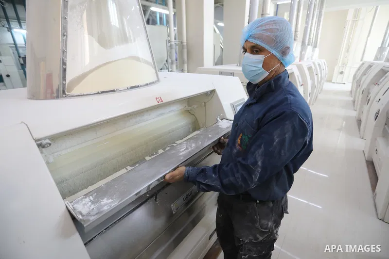 Palestinian workers work in a wheat mill, in Deir al-Balah in the central Gaza Strip, on March 1, 2022. People have raised concerns that Gaza's food supply could be impacted by the Russia-Ukraine conflict, given that the...