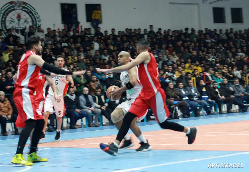 Players of Khadamat al-Maghazi (red) and players of Khadamat al-Burij (white) fight during the Gaza Basketball Cup Final 2022, in Gaza city on March 2, 2022. Khadamat al-Maghazi won the Gaza Basketball Cup 2022 for the s...