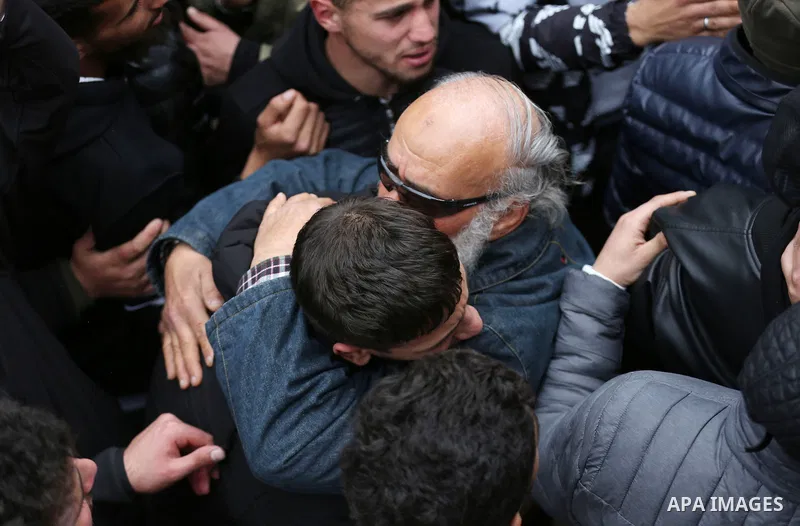 Palestinian mourners carry the body of Ahmad Saif, who died as a result of injuries sustained four days ago during clashes with Israeli soldiers following a demonstration, during his funeral in the West Bank village of B...