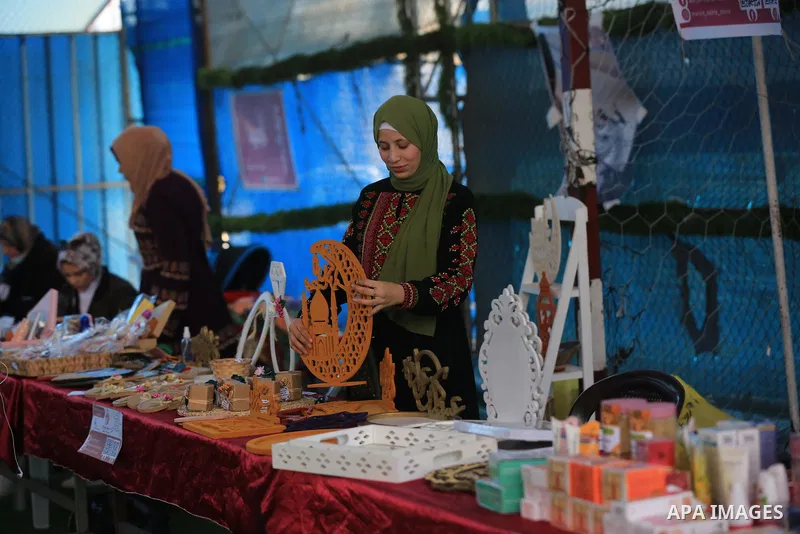 Palestinians attend an exhibition of women's products on the occasion of International Women's Day, in Deir al-Balah in the center of Gaza Strip on March 9, 2022. International Women's Day (IWD) is celebrated on 8 March...