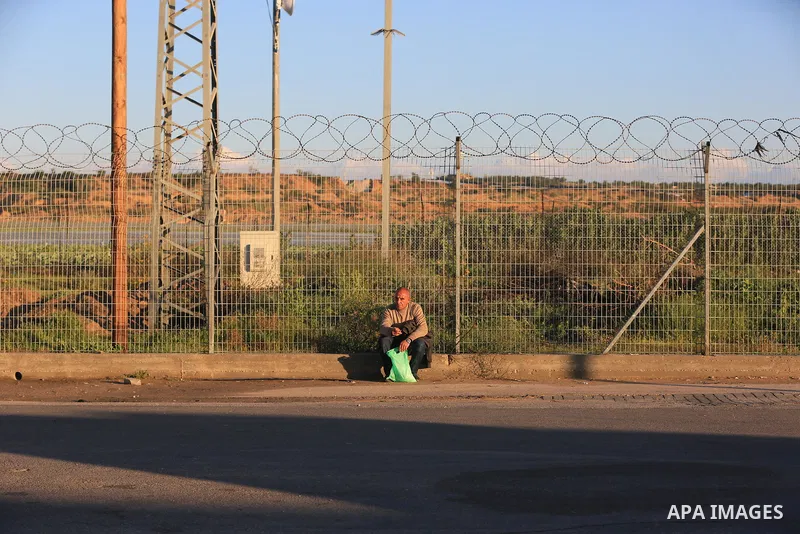 Palestinian workers wait at the Erez crossing as they prepare to leave Beit Hanun in the northern Gaza Strip, to go to work inside Israel, on March 13, 2022. Israel is set to issue another 2,000 work permits for Palestin...