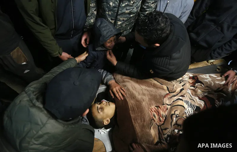 Relatives mourn over the body of 16-year-old Palestinian Nader Rayan who was killed by Israeli forces during a morning raid, at the Rafidia Hospital in Nablus on March 15, 2022. Nader Haitham Rayan died in Balata camp ne...
