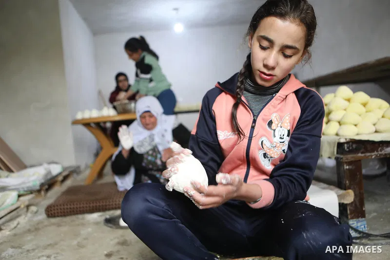 Palestinian family make Jameed in Masafer Yatta, south of Hebron, in the southern West Bank on March 23, 2022. Jameed dry fermented yogurt made from ewe or goat's milk. Jameed is the primary ingredient used to make mansa...