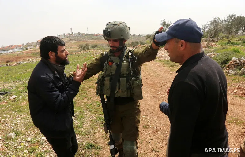 Palestinian farmers scuffle with Israeli security forces which preventing them plant olive trees on their land marking the Palestinian Land Day, at Qusra village near the West Bank City of Nablus on March 29, 2022. Photo...