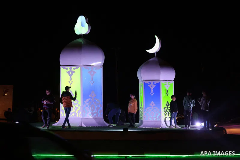 Palestinians take photos near the a huge of a lantern known in Arabic as "Fanous Ramadan", on the first Day of the Muslim fasting month of Ramadan in Gaza City on April 2, 2022. Photo by Osama Baba