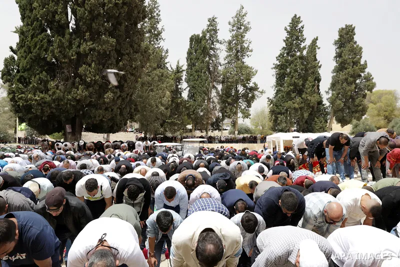 Palestinian Muslim worshippers gather at the Dome of the Rock mosque in the Old City of Jerusalem to attend the first Friday prayer of Ramadan on April 8, 2022. Photo by Jeries Bssier