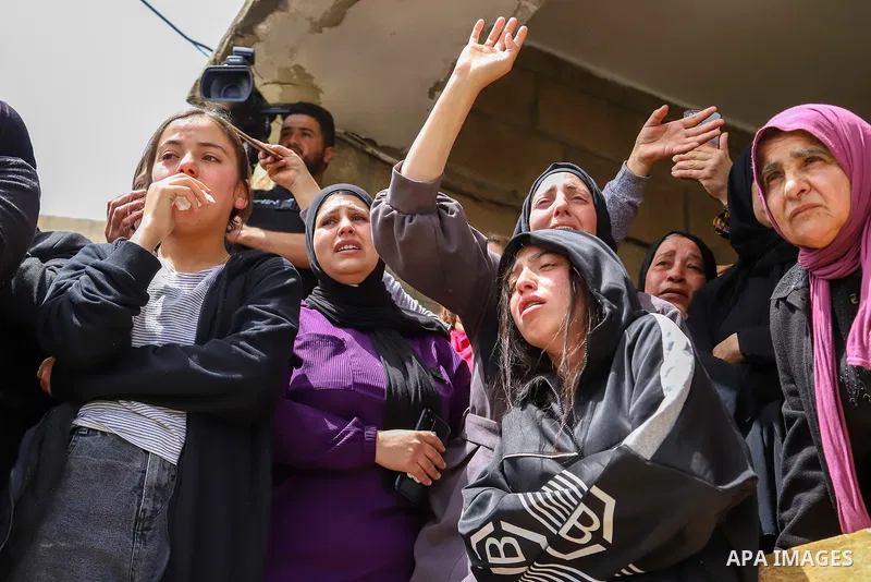 Relatives mourn by the body of Palestinian Mohammed Ghnaim during his funeral in al-Khader village near the West Bank city of Bethlehem, on April 11, 2022, a day after he was shot dead by the Israeli army. Photo by Ihab...