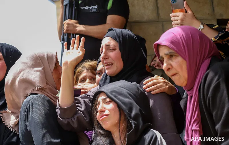 Relatives mourn by the body of Palestinian Mohammed Ghnaim during his funeral in al-Khader village near the West Bank city of Bethlehem, on April 11, 2022, a day after he was shot dead by the Israeli army. Photo by Ihab...