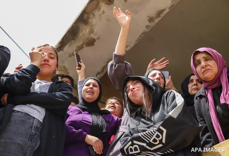 Relatives mourn by the body of Palestinian Mohammed Ghnaim during his funeral in al-Khader village near the West Bank city of Bethlehem, on April 11, 2022, a day after he was shot dead by the Israeli army. Photo by Ihab...
