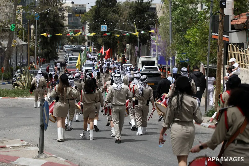 Palestinian Scout bands perform during Palm Sunday in the West Bank city of Ramallah on April 17, 2022. Palm Sunday commemorates the day the Gospel says Jesus rode into Jerusalem on a donkey and was hailed by the people,...