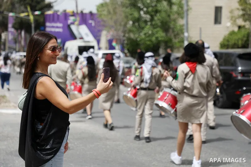 Palestinian Scout bands perform during Palm Sunday in the West Bank city of Ramallah on April 17, 2022. Palm Sunday commemorates the day the Gospel says Jesus rode into Jerusalem on a donkey and was hailed by the people,...