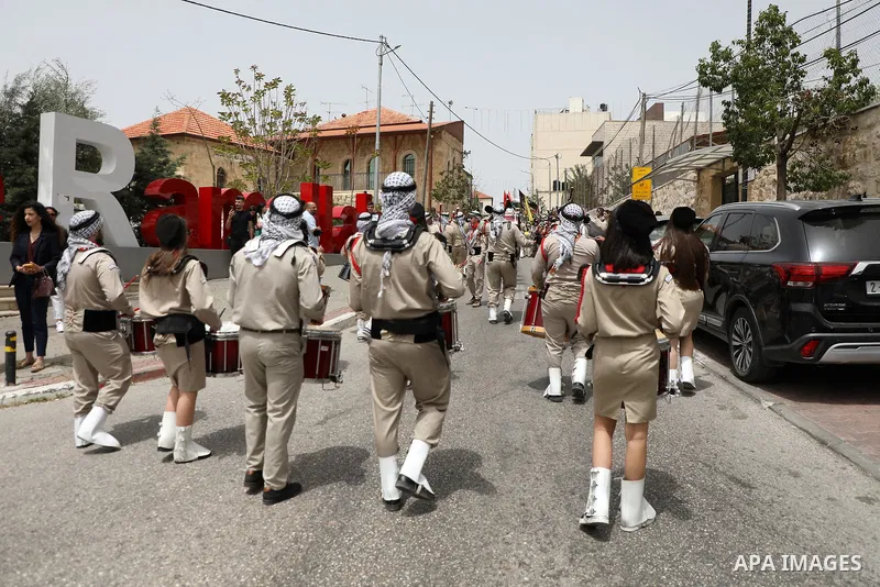 Palestinian Scout bands perform during Palm Sunday in the West Bank city of Ramallah on April 17, 2022. Palm Sunday commemorates the day the Gospel says Jesus rode into Jerusalem on a donkey and was hailed by the people,...