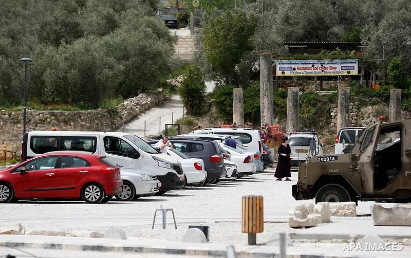 Israeli Jewish settlers visitors are seen at an ancient Roman historical site as they celebrating the Jewish holiday of Passover, in the village of Sebastia, near the West Bank city of Nablus, April 18, 2022. The ancient...