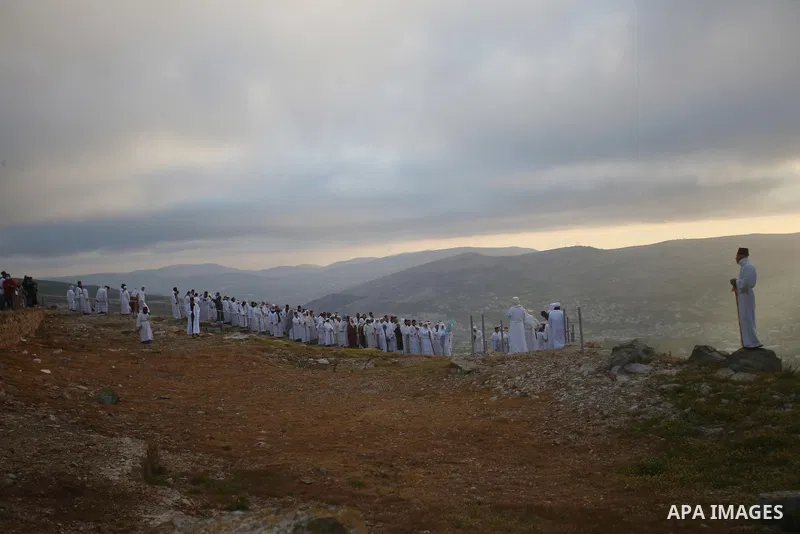 Samaritan worshippers arrive to take part in a Passover ceremony on top of Mount Gerizim, near the northern West Bank city of Nablus, early on April 21, 2022. The Samaritans are a community of a few hundred people living...