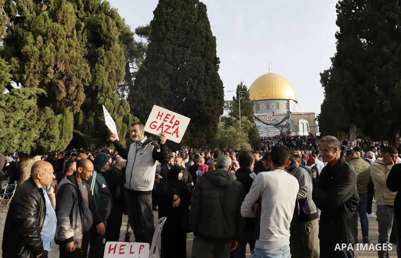 Palestinian Muslim worshipers perform the Eid al-Fitr prayer celebrating the end of the holy Muslim fasting month of Ramadan at the Al-Aqsa mosques compound in old Jerusalem on May 02, 2022. Photo by Jeries Bssier