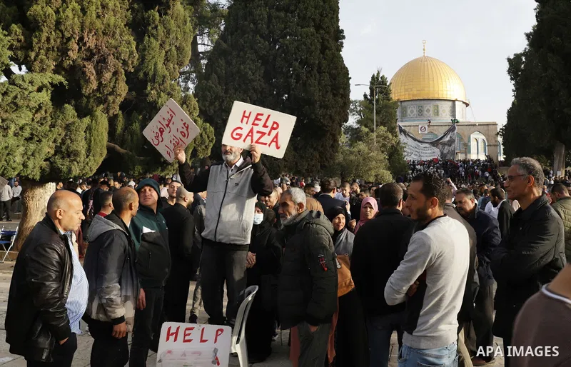 Palestinian Muslim worshipers perform the Eid al-Fitr prayer celebrating the end of the holy Muslim fasting month of Ramadan at the Al-Aqsa mosques compound in old Jerusalem on May 02, 2022. Photo by Jeries Bssier