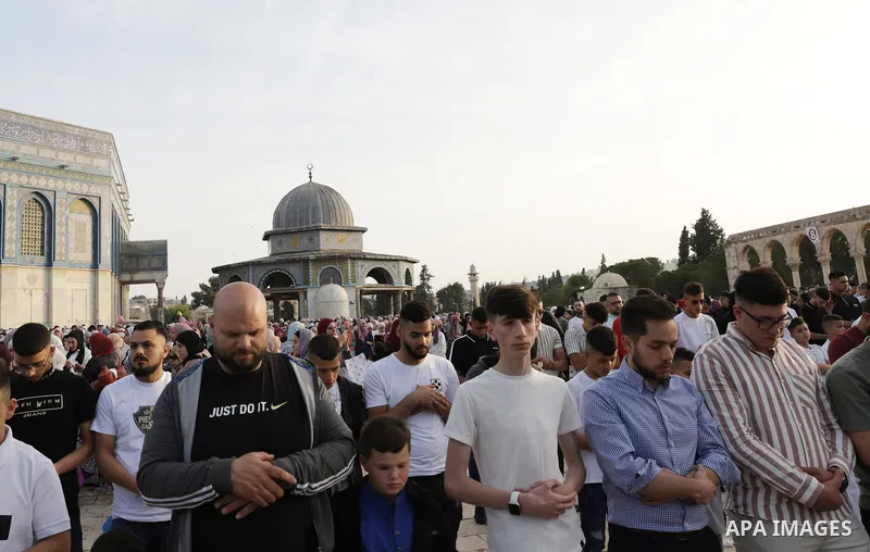Palestinian Muslim worshipers perform the Eid al-Fitr prayer celebrating the end of the holy Muslim fasting month of Ramadan at the Al-Aqsa mosques compound in old Jerusalem on May 02, 2022. Photo by Jeries Bssier