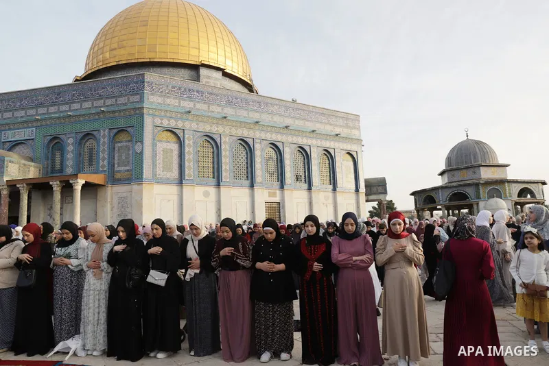 Palestinian Muslim worshipers perform the Eid al-Fitr prayer celebrating the end of the holy Muslim fasting month of Ramadan at the Al-Aqsa mosques compound in old Jerusalem on May 02, 2022. Photo by Jeries Bssier