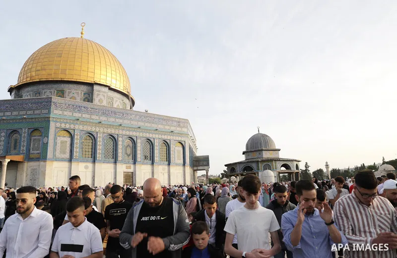Palestinian Muslim worshipers perform the Eid al-Fitr prayer celebrating the end of the holy Muslim fasting month of Ramadan at the Al-Aqsa mosques compound in old Jerusalem on May 02, 2022. Photo by Jeries Bssier