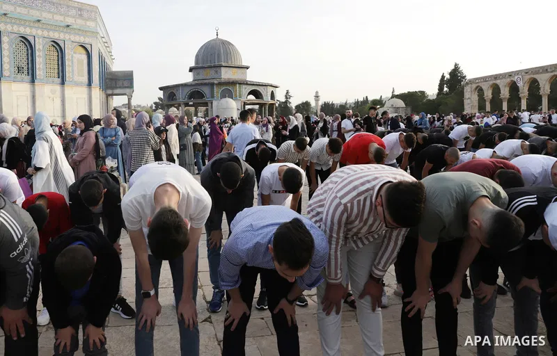Palestinian Muslim worshipers perform the Eid al-Fitr prayer celebrating the end of the holy Muslim fasting month of Ramadan at the Al-Aqsa mosques compound in old Jerusalem on May 02, 2022. Photo by Jeries Bssier