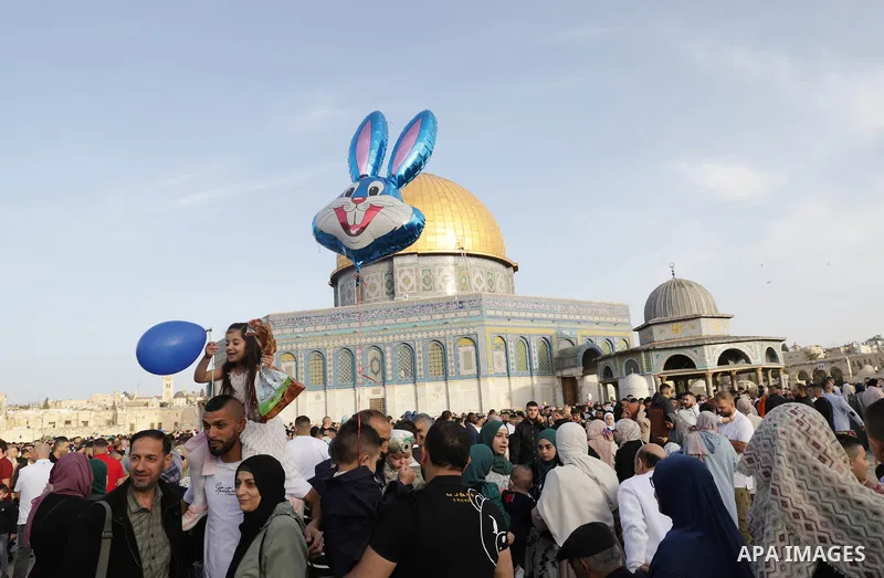 Palestinian Muslim worshipers perform the Eid al-Fitr prayer celebrating the end of the holy Muslim fasting month of Ramadan at the Al-Aqsa mosques compound in old Jerusalem on May 02, 2022. Photo by Jeries Bssier